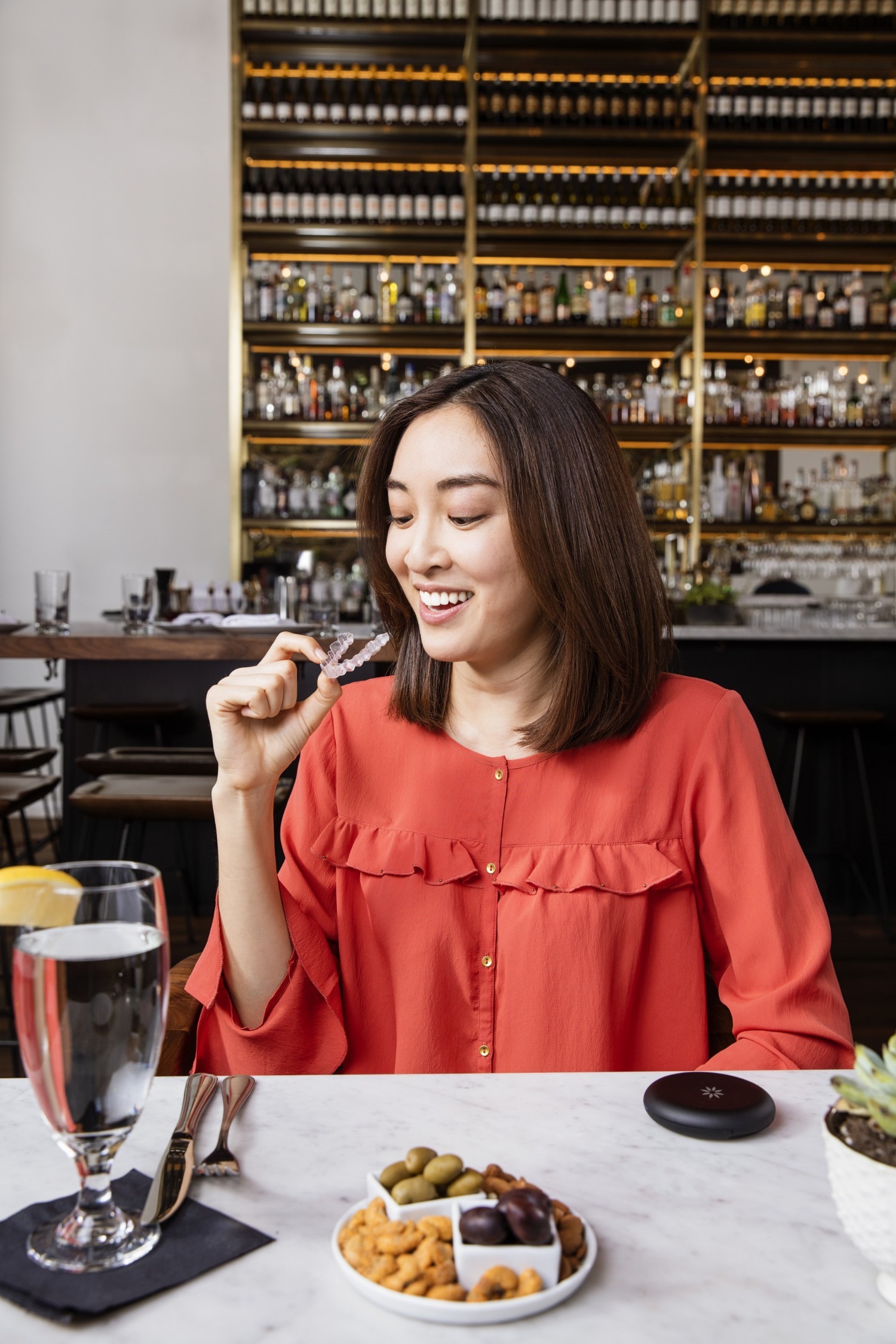 Lady in a cafe with Invisalign